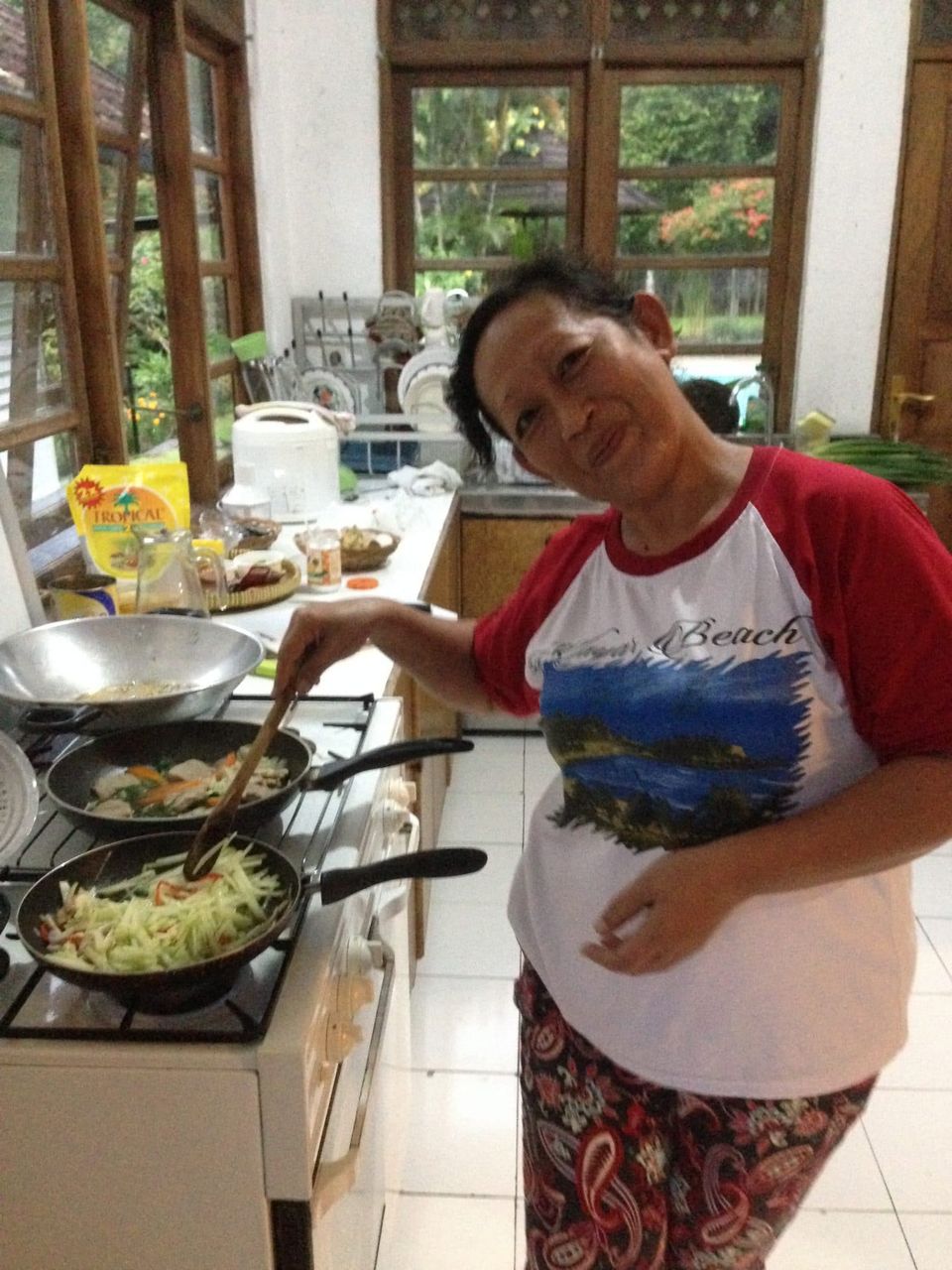 Javanese cooking class: staff teaches guests traditional recipes in the villa kitchen